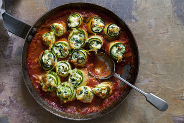 Courgette stuffed with ricotta, spinach and peas in tomato sauce