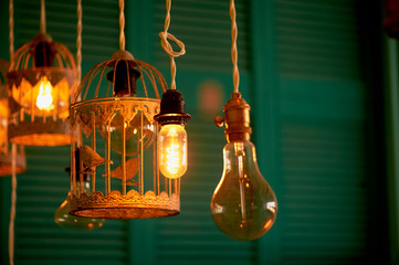 Bulbs Erickson suspended with the cells with the decoration bird. Yellow warm lamp light