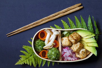 Japanese bento box lunch withg mushrooms, onigiri and tofu