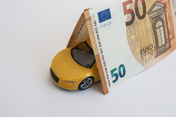 yellow car on a white background and the roof of the money in fifty euros