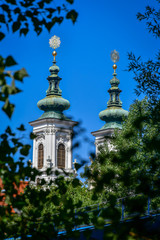 Fototapeta na wymiar two church spires through trees