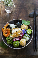 Bento bowl with onigiri, prawns and vegetables