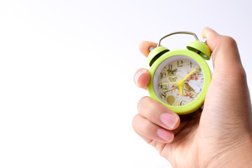 hand with alarm clock isolated against white background, time management concept.
