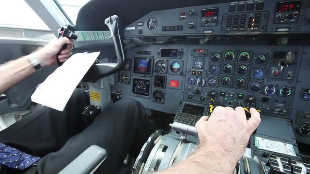 Close up, pilot sits in plane cockpit