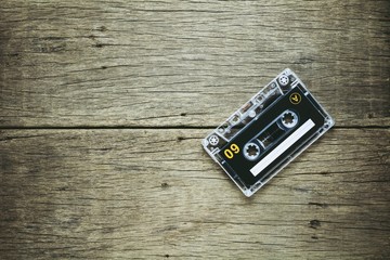 vintage audio cassette tapes on wooden background. - vintage backdrop style.