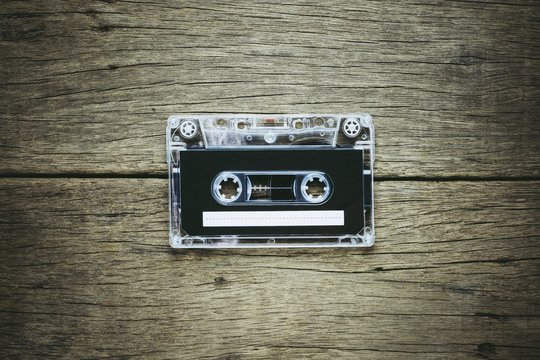 vintage audio cassette tapes on wooden background. - vintage backdrop style.