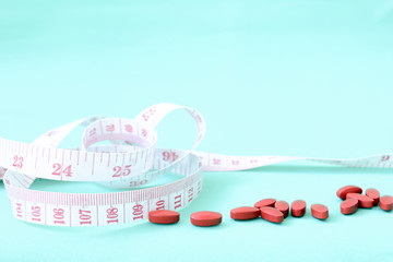 Weight loss for a limited time by taking medicine, Weight loss pills with clock and measuring tape - 219453573