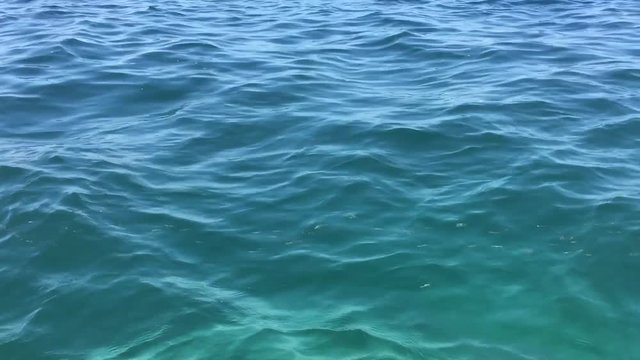 Dark blue green wavy rippled sea water surface