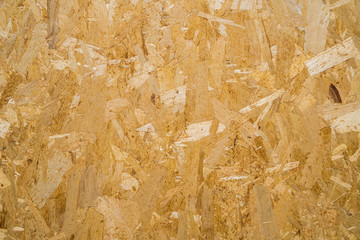 close up pressed wooden panel background, seamless texture of oriented strand board - OSB wood