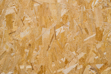 close up pressed wooden panel background, seamless texture of oriented strand board - OSB wood