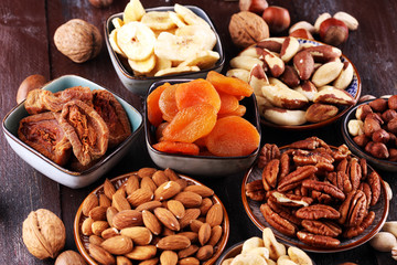 dried fruits and assorted nuts composition on rustic table