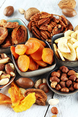 dried fruits and assorted nuts composition on rustic table
