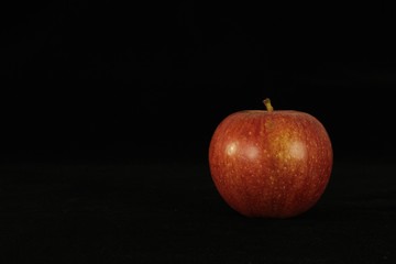Apple or apples whole or sliced in half on black background.