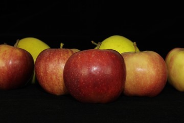 Fototapeta na wymiar Single or group of apples including granny smith, golden delicious and royal gala on a black background.