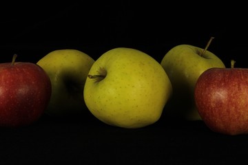 Fototapeta na wymiar Single or group of apples including granny smith, golden delicious and royal gala on a black background.