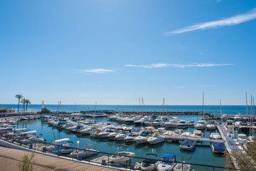 Yachting port with fishing boats and sport yachts in the Mediterranean Sea on a summer day