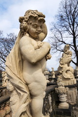 Fototapeta premium Statues around Nymphenbad at baroque Zwinger palace in Dresden, Germany, sunny spring day
