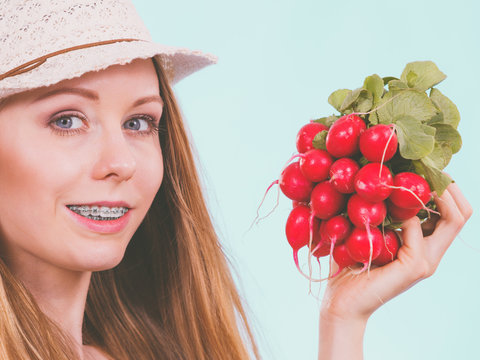 Happy woman holding radish