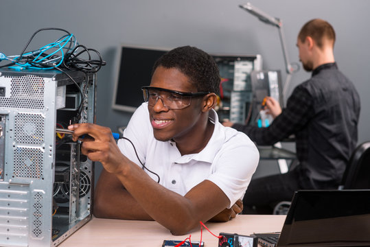 Men repairing electronics