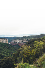Obraz premium morning mist in the mountain peaks on natural landscape. Green valley on background foggy dramatic sky, mountain tops. Panorama horizon perspective view. Travel mockup concept