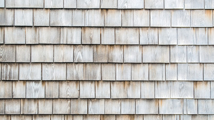 background texture close up of weathered wooden shingles on a vintage colonial building in...