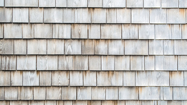 background texture close up of weathered wooden shingles on a vintage colonial building in Massachusetts