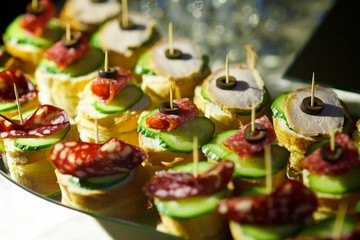 Canape and sandwiches with meat and sausage.