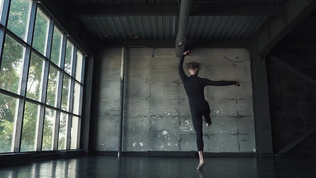 young male dancer ballet danced on tiptoe in studio. slow motion