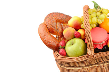 A set of fruits and pastries in a woven basket isolated on white background. Free space for text.