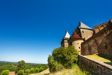 Fototapeta na wymiar Medieval Biron castle against blue sky, France