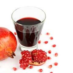 Pomegranate juice in a glass and ripe pomegranates. Isolated on white background. Free space for text.