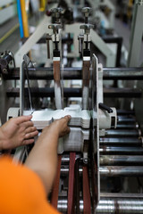 Close up shot of worker's hand preparing carton for printing in a modern printing house.