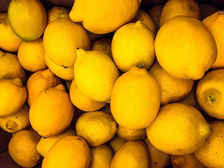 The background texture is a lot of yellow lemons. Healthy lifestyle.