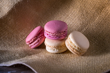 Macarons on burlap and wood surface