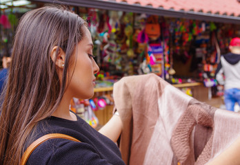 Obraz premium Close up of young woman holding in her hands a handmade at a craft store in the Passage Craft in the downtown of the city of Banos