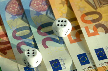Banknotes and Euro coins with dice, what a future. 