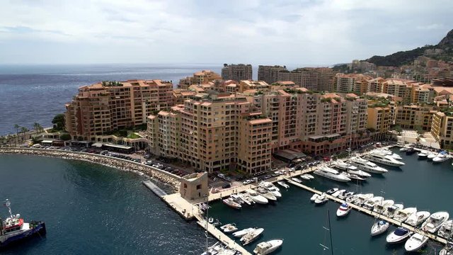 Left to right panoramic view of Monaco in spring of 2018, water with yachts and vehicles on the road. Sea view in the wind. Real time medium shot