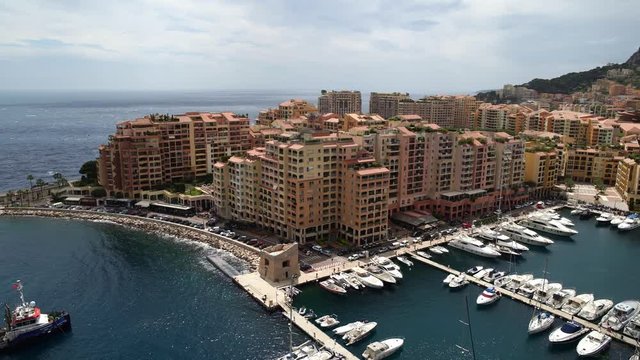 Left to right panoramic view of Monaco in spring of 2018, water with yachts and cars on the road. Sea view in the wind. Real time medium shot
