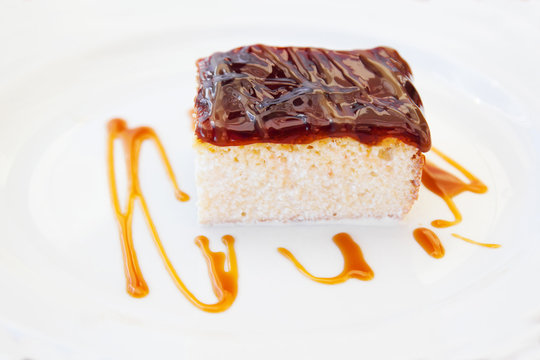 Threemilk cake on white plate; Trilece Albanian cake with three types of milk  and caramel