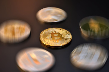 Obraz na płótnie Canvas bitcoin gold coin with other digital crypto coins out of focus