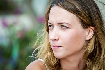 Naklejka premium A pensive Caucasian girl contemplating, her face isolated close up image.