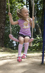 girl rides a swing