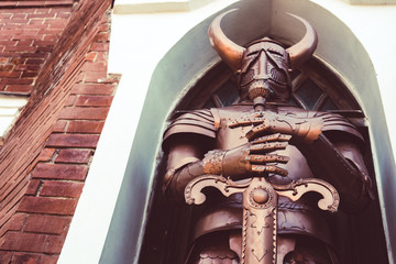 knight wearing armor and holding two-handed sword