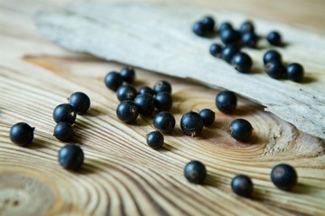Berries fresh organic black currant lie on a wooden the surface.