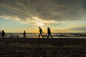family on beach sunset