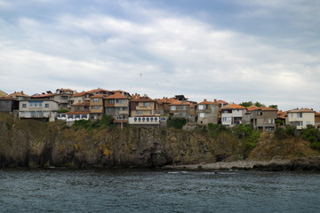 Fototapeta na wymiar The town of Sozopol is on a rocky beach overlooking the sea. Colorful houses of an ancient city in Bulgaria.