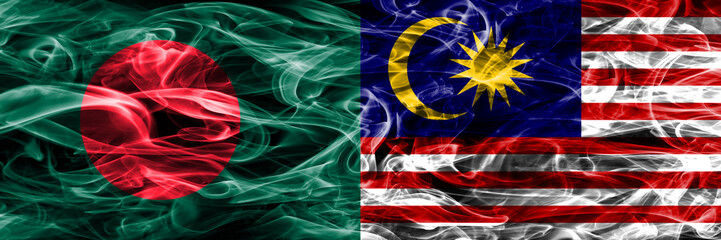 Bangladesh vs Malaysia smoke flags placed side by side. Thick colored silky smoke flags of Bangladesh and Malaysia
