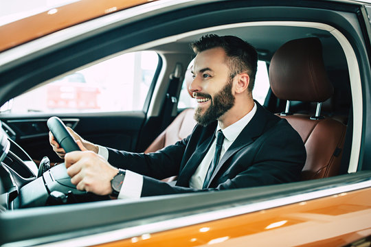 Portrait Of Happy Businessman While Driving His New Car At First Time