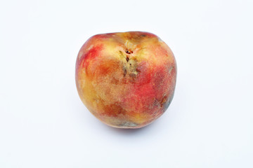 mold growing on old peach, isolated on white background