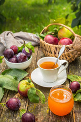 Eating apples juice pie coffee tea on a picnic in nature in a rustic garden on a sunny afternoon, the concept of outdoor recreation, travel and food